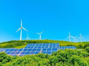 Peisaj cu turbine eoliene și panouri solare în România.